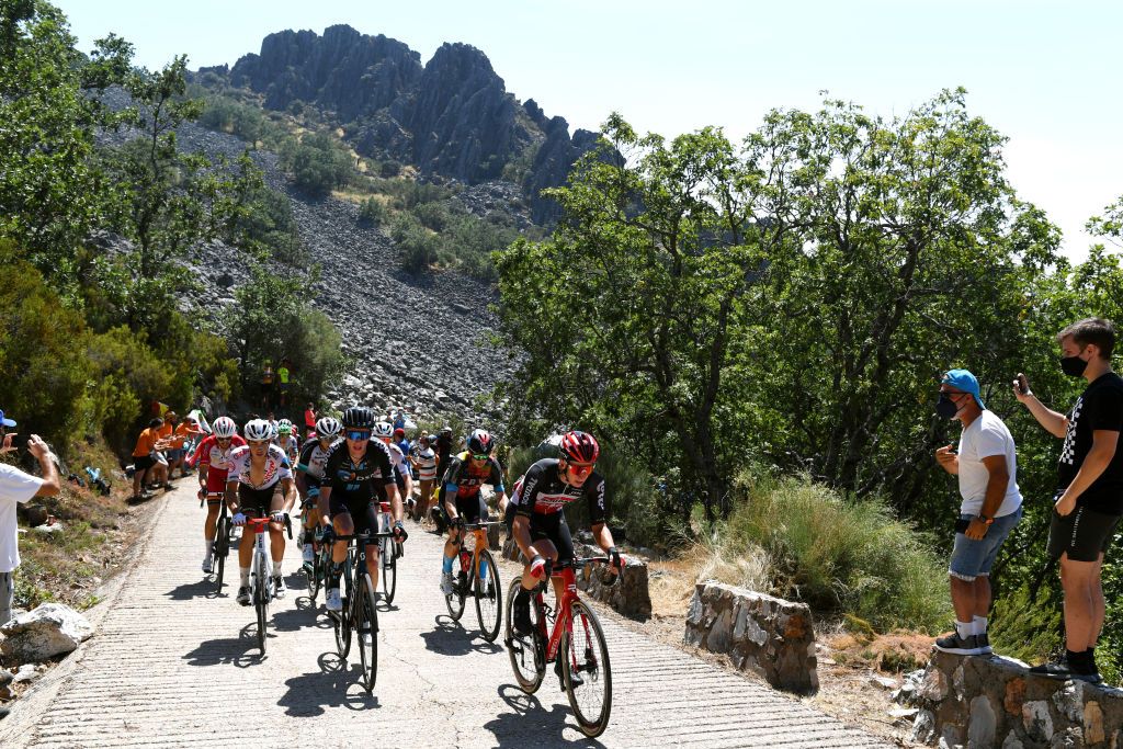 PICO VILLUERCAS SPAIN AUGUST 28 A general view of Clment Champoussin of France and AG2R Citren Team Jan Tratnik of Slovenia and Team Bahrain Victorious Aritz Bagues Kalparsoro of Spain and Team Caja RuralSeguros RGA Jess Herrada Lopez of Spain and Team Cofidis Jens Keukeleire of Belgium and Team EF Education Nippo Xavier Mikel Azparren Irurzun of Spain and Team Euskaltel Euskadi Arnaud Demare of France and Team Groupama FDJ Kevin Geniets of Luxembourg and Team Groupama FDJ Davide Cimolai of Italy and Team Israel StartUp Nation Sep Vanmarcke of Belgium and Team Israel StartUp Nation Andrey Zeits of Kazahkstan and Team BikeExchange Romain Bardet of France and Team DSM Dylan Sunderland of Australia and Team Qhubeka Nexthash and Ryan Gibbons of South Africa and UAE Team Emirates in the chase group climb the Alto Collado de Ballesteros 1415m while fans cheer during the 76th Tour of Spain 2021 Stage 14 a 1657km stage from Don Benito to Pico Villuercas 1580m lavuelta LaVuelta21 on August 28 2021 in Pico Villuercas Spain Photo by Tim de WaeleGetty Images