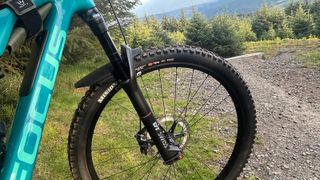 DT Swiss F535 One fork on bike with track, trees and hills in background