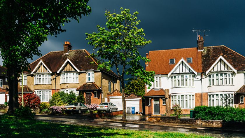 street of houses with black storm clouds 