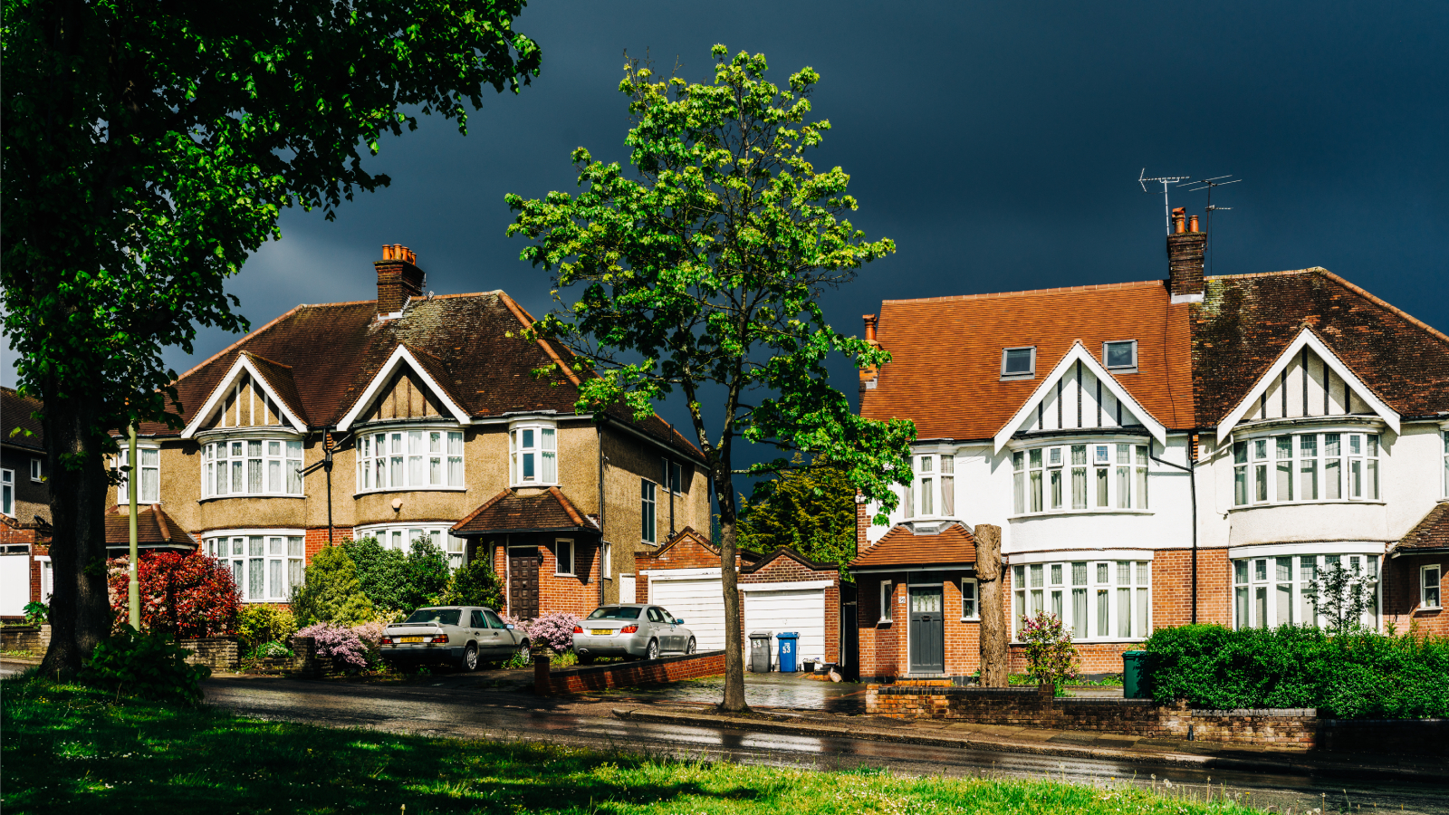 street of houses with black storm clouds 