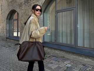 Woman carrying a The Row Margaux bag