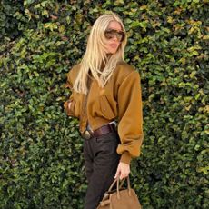Elsa Hosk wearing an autumnal bomber jacket with a '90s layered hairstyle