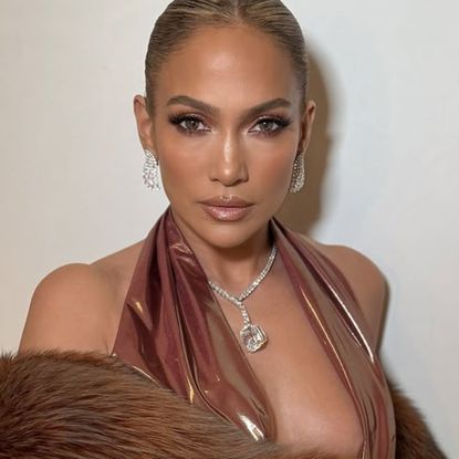 Jennifer Lopez wears a plunging, backless dress with a Harry Kotler cushion-cut diamond drop necklace worth 25 million dollars