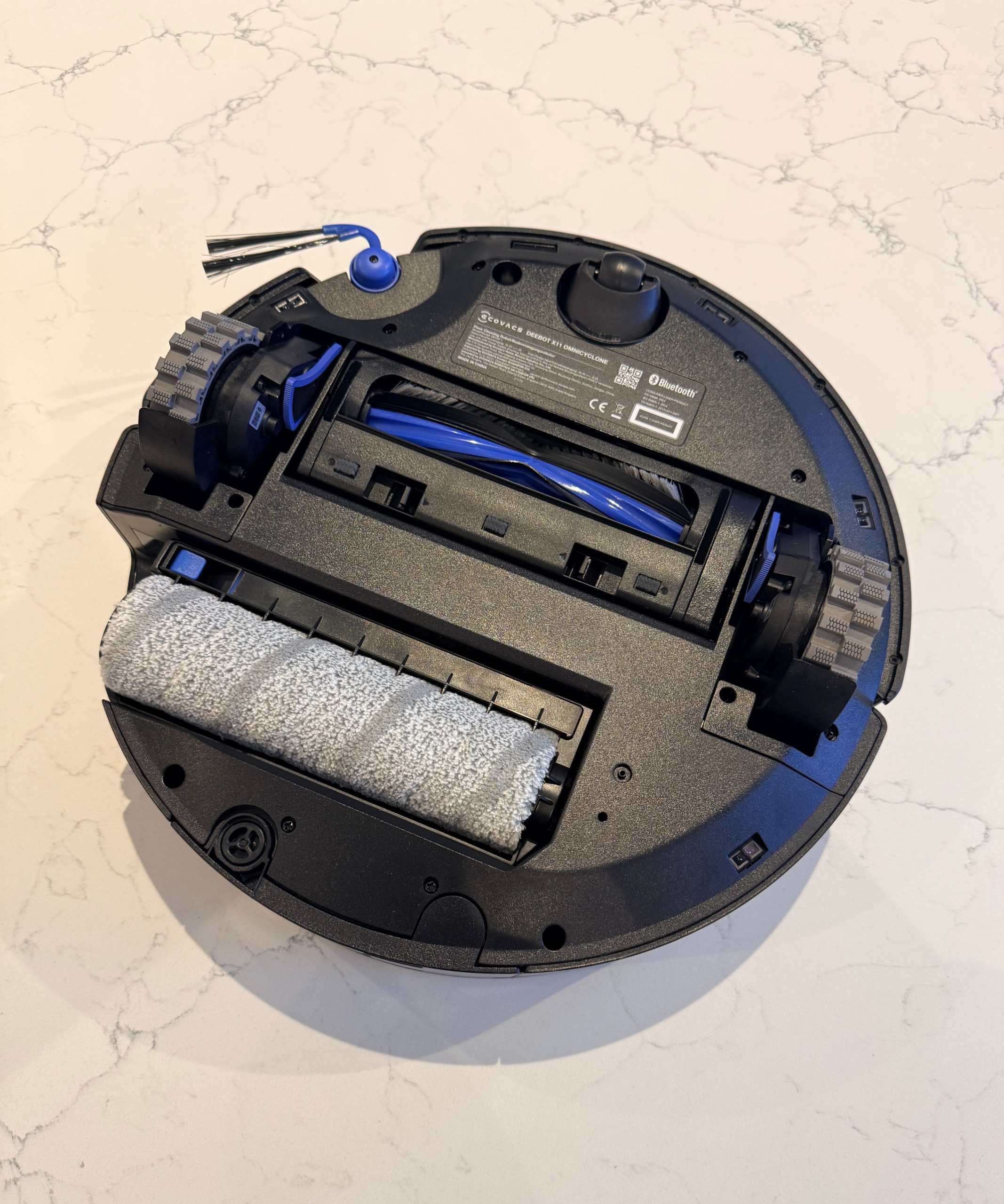 Underside of ECOVACS DEEBOT X11 OmniCyclone showing wheels, brushes and roller mop