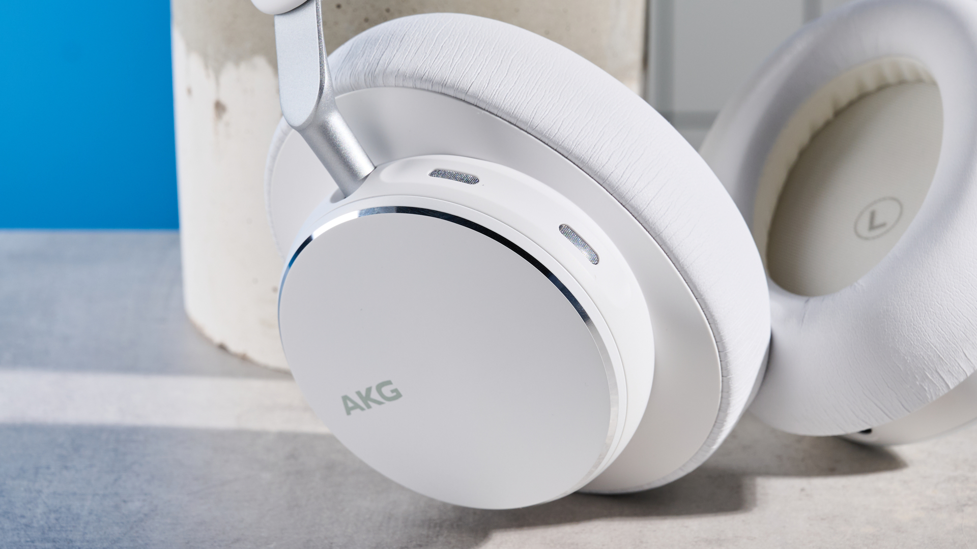 The AKG N9 Hybrid headphones photographed in front of a blue background.