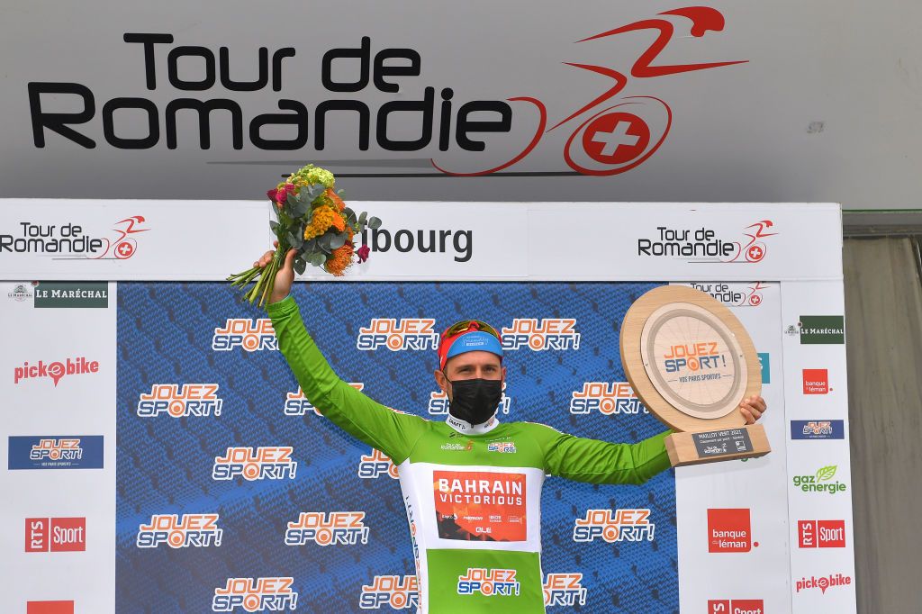 FRIBOURG SWITZERLAND MAY 02 Sonny Colbrelli of Italy and Team Bahrain Victorious Green Points Jersey celebrates at podium during the 74th Tour De Romandie 2021 Stage 5 a 1619km Individual Time Trial stage from Fribourg to Fribourg 614m Trophy Mask Covid Safety Measures ITT TDR2021 TDRnonstop UCIworldtour on May 02 2021 in Fribourg Switzerland Photo by Luc ClaessenGetty Images
