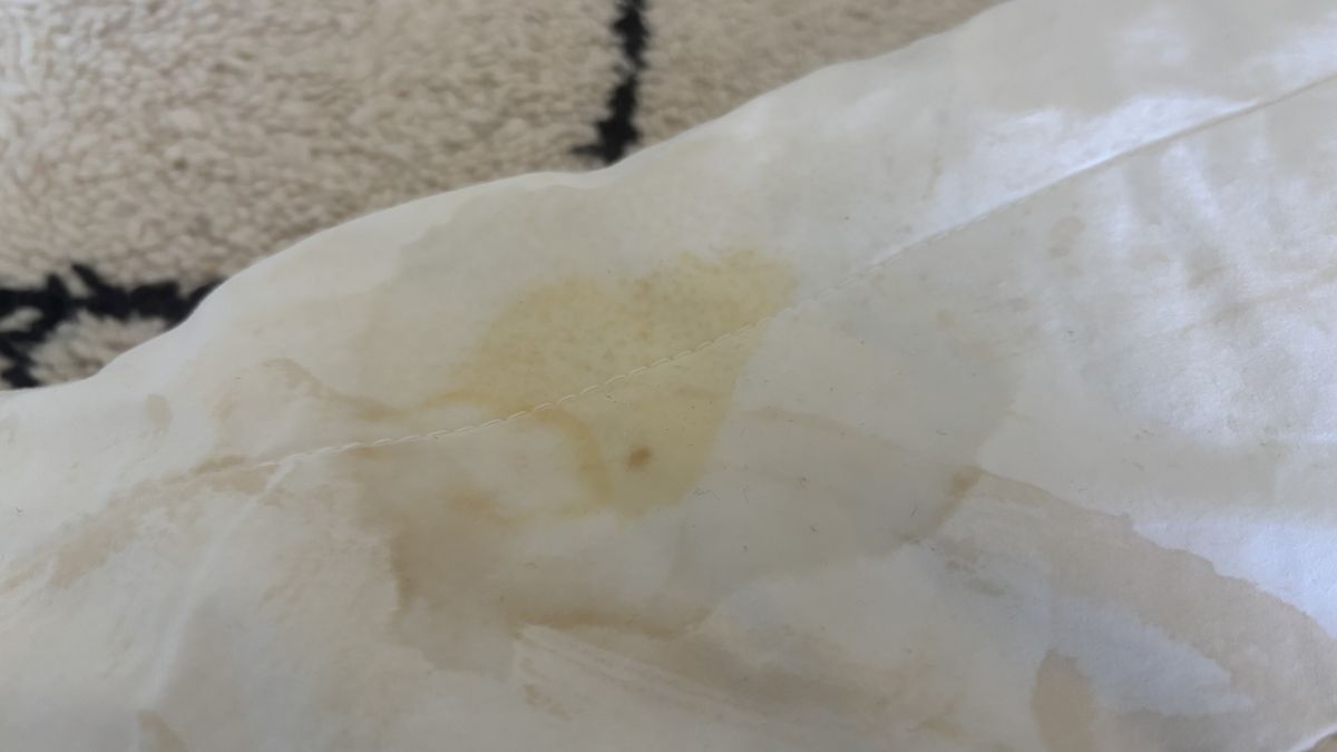 A stained pillow with shaving foam residue.