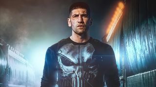 Jon Bernthal's The Punisher stands in an underground tunnel in his classic comic book costume