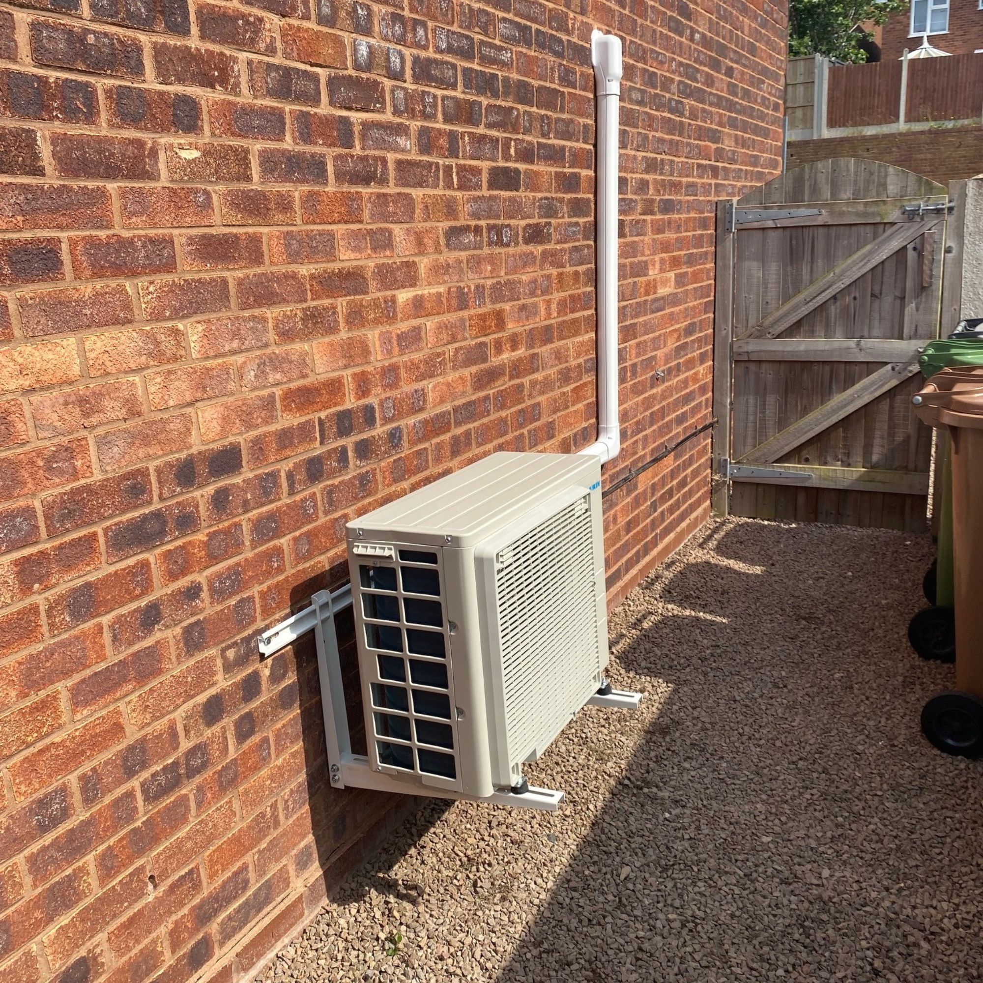 Outdoor air con unit mounted on the wall with a bracket
