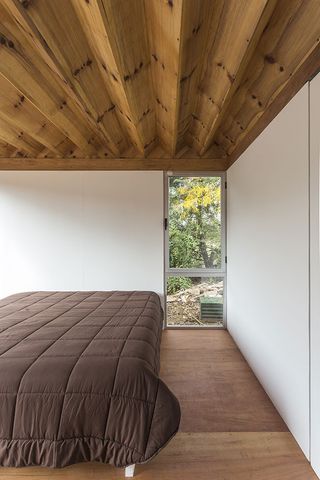 Interiors are simple and windows offer views out onto the surrounding greenery