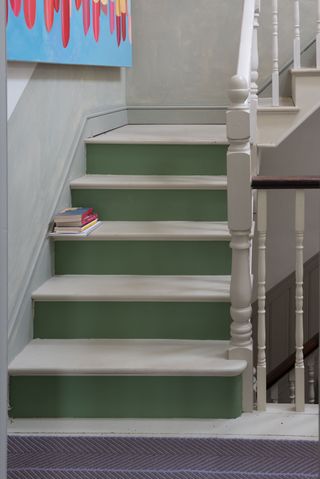 a staircase with green painted risers