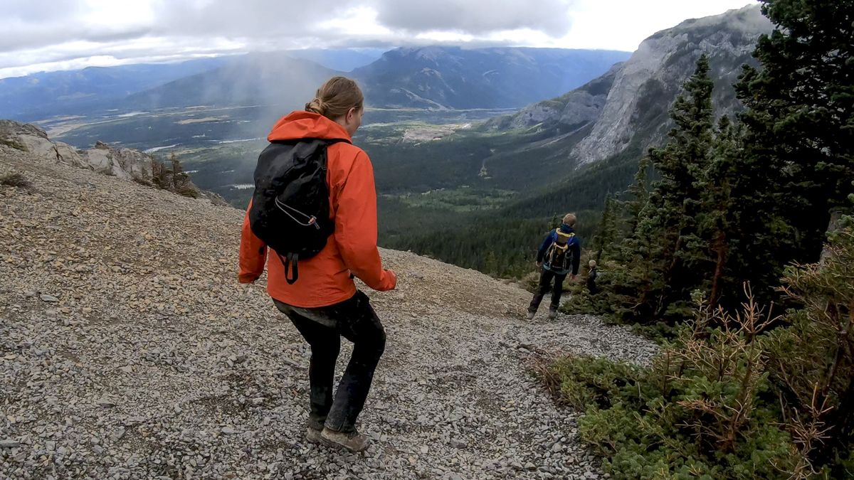 A woman running down a scree slope