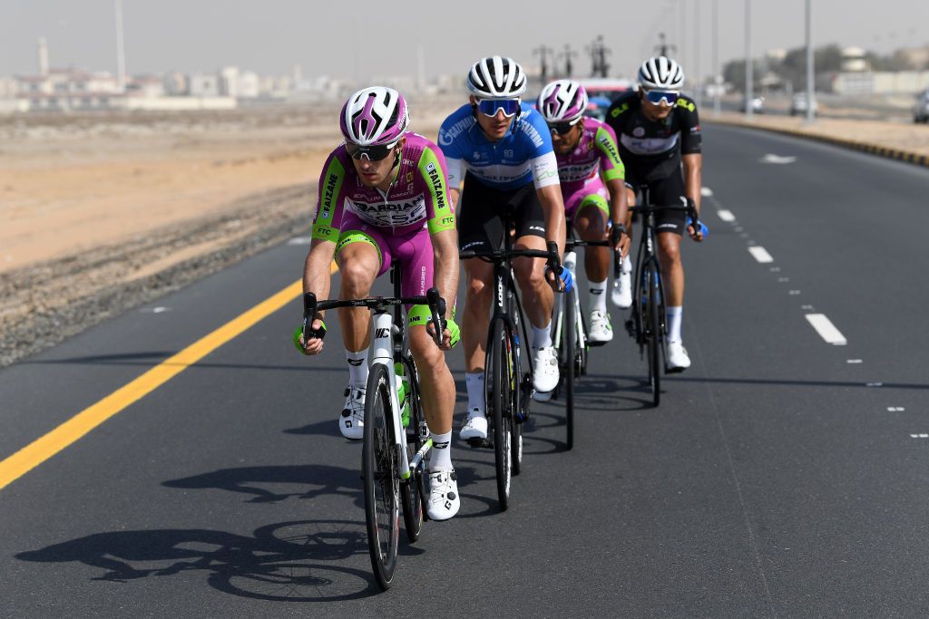 AL MARJAN UNITED ARAB EMIRATES FEBRUARY 24 LR Alessandro Tonelli of Italy and Team Bardiani Csf Faizane Pavel Kochetkov of Russia and Team Gazprom Rusvelo Jonathan Caaveral Vargas of Colombia and Team Bardiani Csf Faizane and Dmitrii Strakhov of Russia and Team Gazprom Rusvelo most aggressive jersey compete in the breakaway during the 4th UAE Tour 2022 Stage 5 a 182km stage from Ras al Khaimah Corniche to Al Marjan Island UAETour WorldTour on February 24 2022 in Al Marjan United Arab Emirates Photo by Tim de WaeleGetty Images