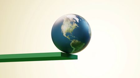 Conceptual image of the earth about to fall off the edge of a green plank 
