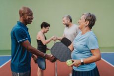 Group of people shaking hands ending pickleball game