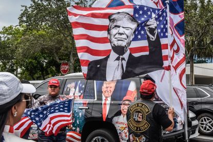 Trump supporters hold signs and wave flags in Miami