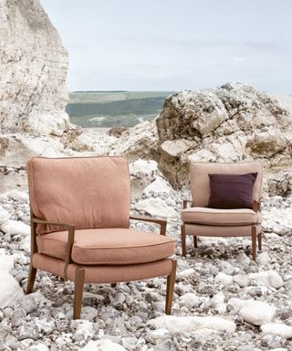 pair of wooden mid century armchairs with sustainable upholstery on beach