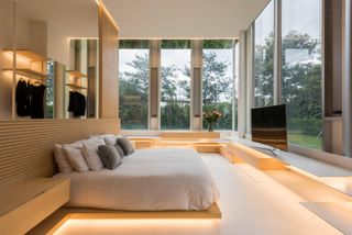 Bedroom with large windows at Llano Apartment, Mexico City, by Archetonic