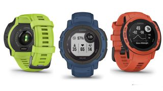 Garmin Instinct 2 watches in lime green, navy blue, and poppy red