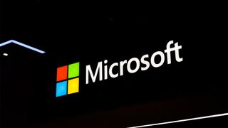 Microsoft logo and branding illuminated against a dark backdrop on the company's vendor stall at Fira Gran Via during Mobile World Congress (MWC) 2026.