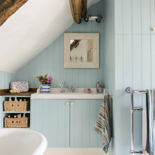 blue bathroom with built in vanity unit gabled roof fitted shelving units rolltop bath