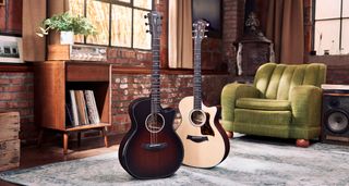 Taylor Next Generation Grand Auditorium: the two refreshed cutaway electro-acoustic guitars are photographed in front of a green sofa and a vintage hi-fi unit.