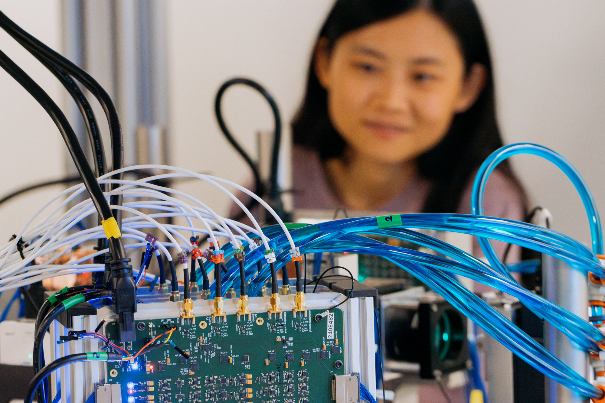 Woman standing behind the analog optical computer.