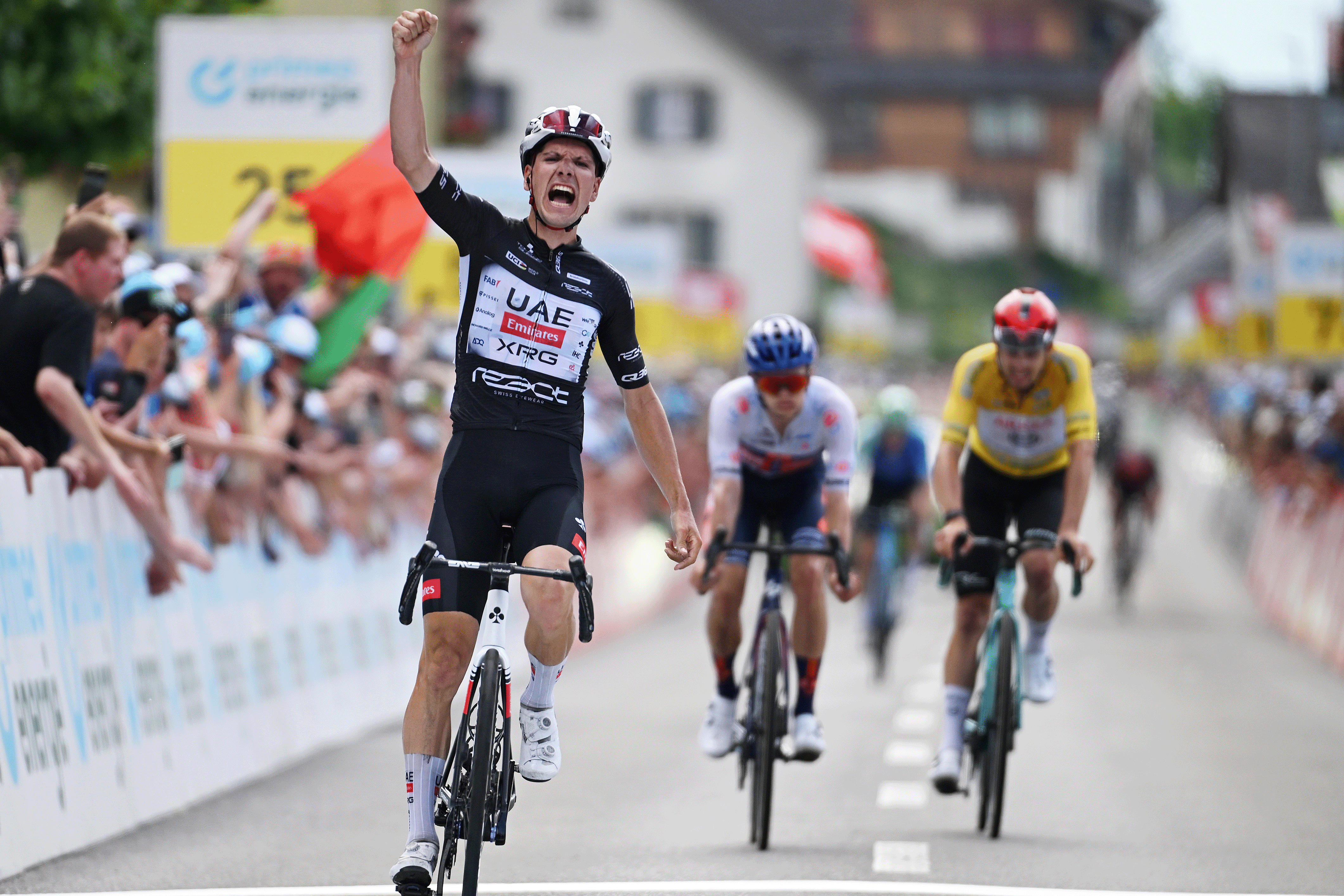 EMMETTEN, SWITZERLAND - JUNE 21: (L-R) Joao Almeida of Portugal and UAE Team Emirates - XRG - Black Points Jersey celebrates at finish line as stage winner ahead of Oscar Onley of Great Britain and Team Picnic PostNL - White best young jersey and Kevin Vauquelin of France and Team Arkea - B&B Hotels - Yellow leader jersey during the 88th Tour de Suisse 2025, Stage 7 a 207.3km stage from Neuhausen am Rheinfall to Emmetten 755m / #UCIWT / on June 21, 2025 in Emmetten, Switzerland. (Photo by Tim de Waele/Getty Images)