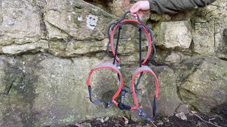 how to put on a climbing harness: holding harness up