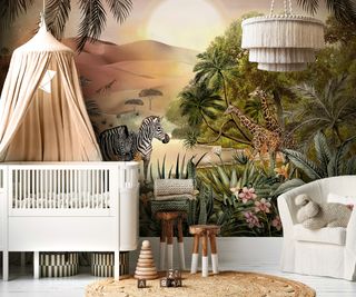 child's bedroom with jungle wall mural, large fabric tassel pendant light above chair with cot and canopy to other side