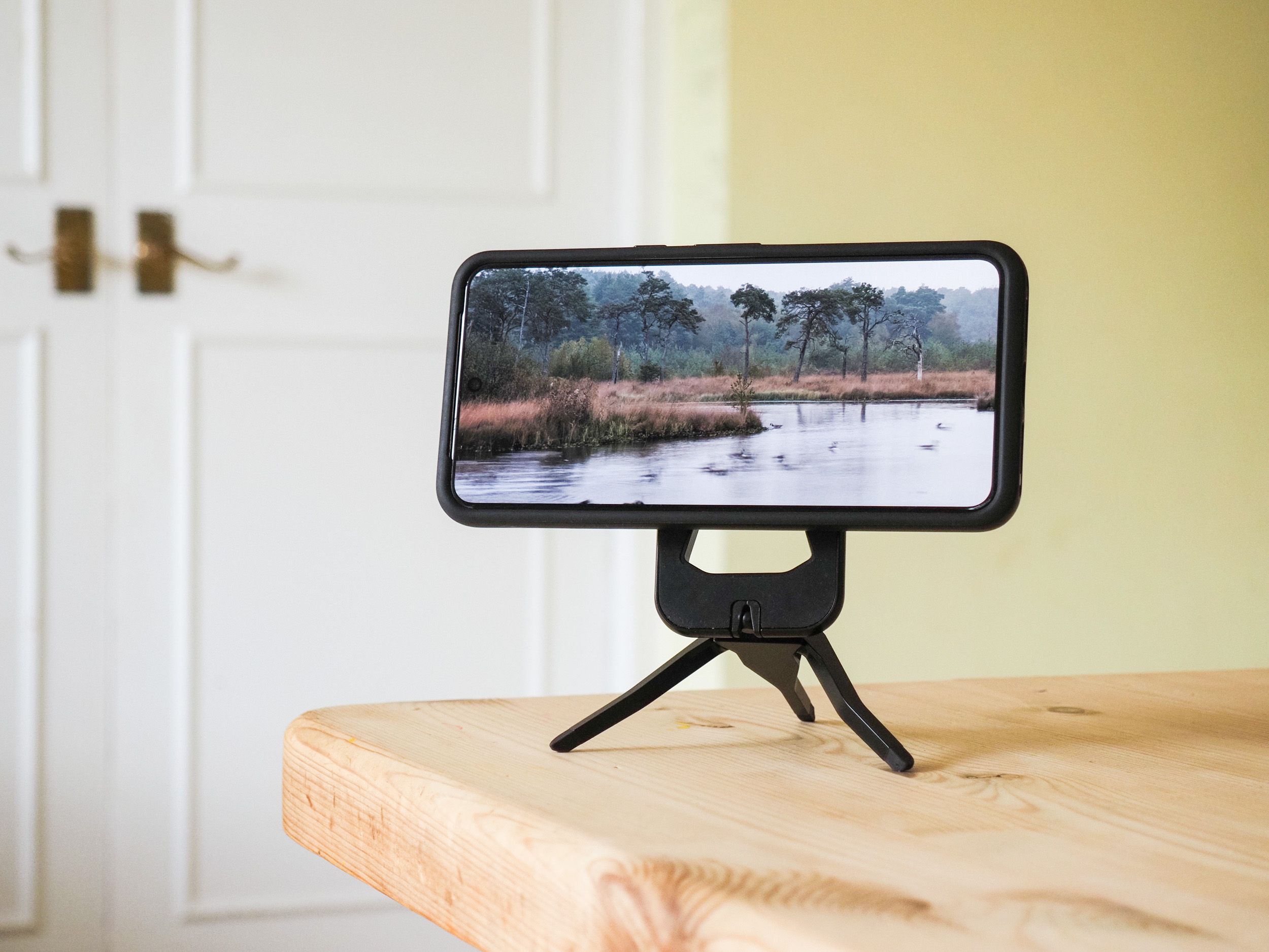 Peak Design Mobile Tripod folded away in use on a table, with a Pixel phone attached