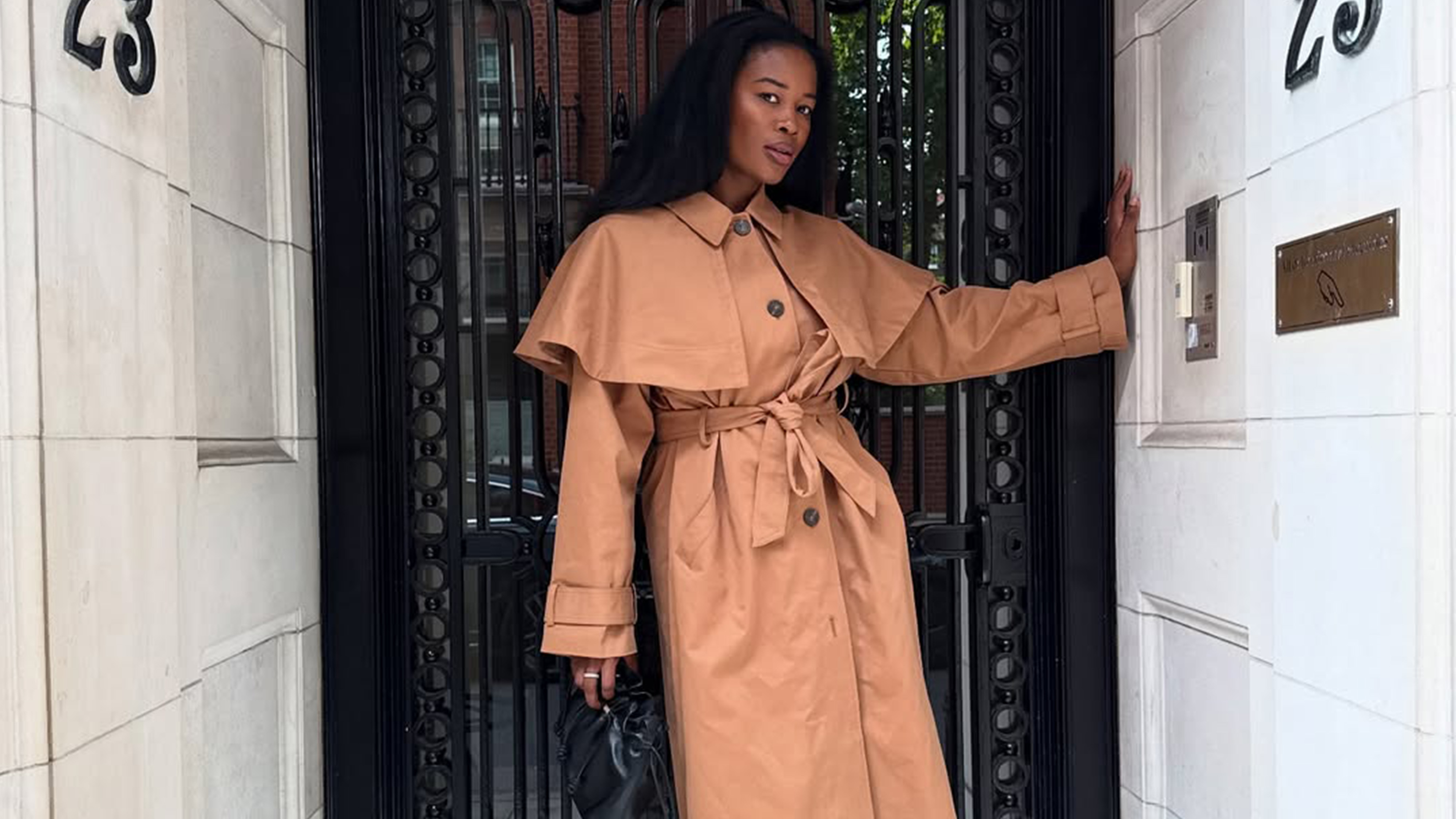 Marilyn NK wearing a trench coat.