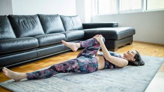 A woman doing yoga at home