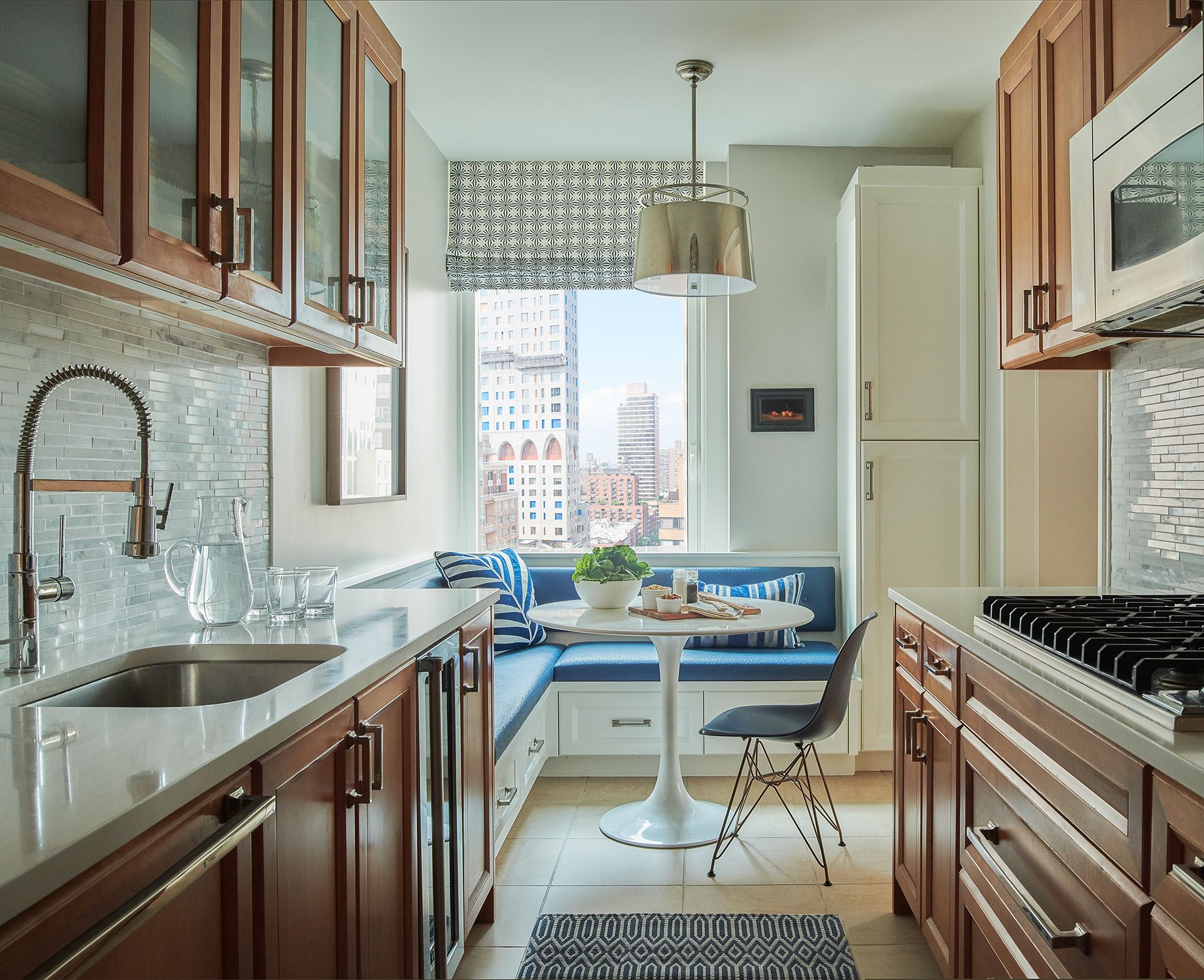 galley kitchen with wooden cabinetry and windowseat
