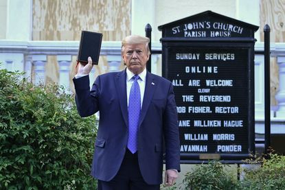 Donald Trump holds a Bible.