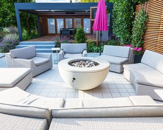 patio with furniture and fire pit with pebble inlay