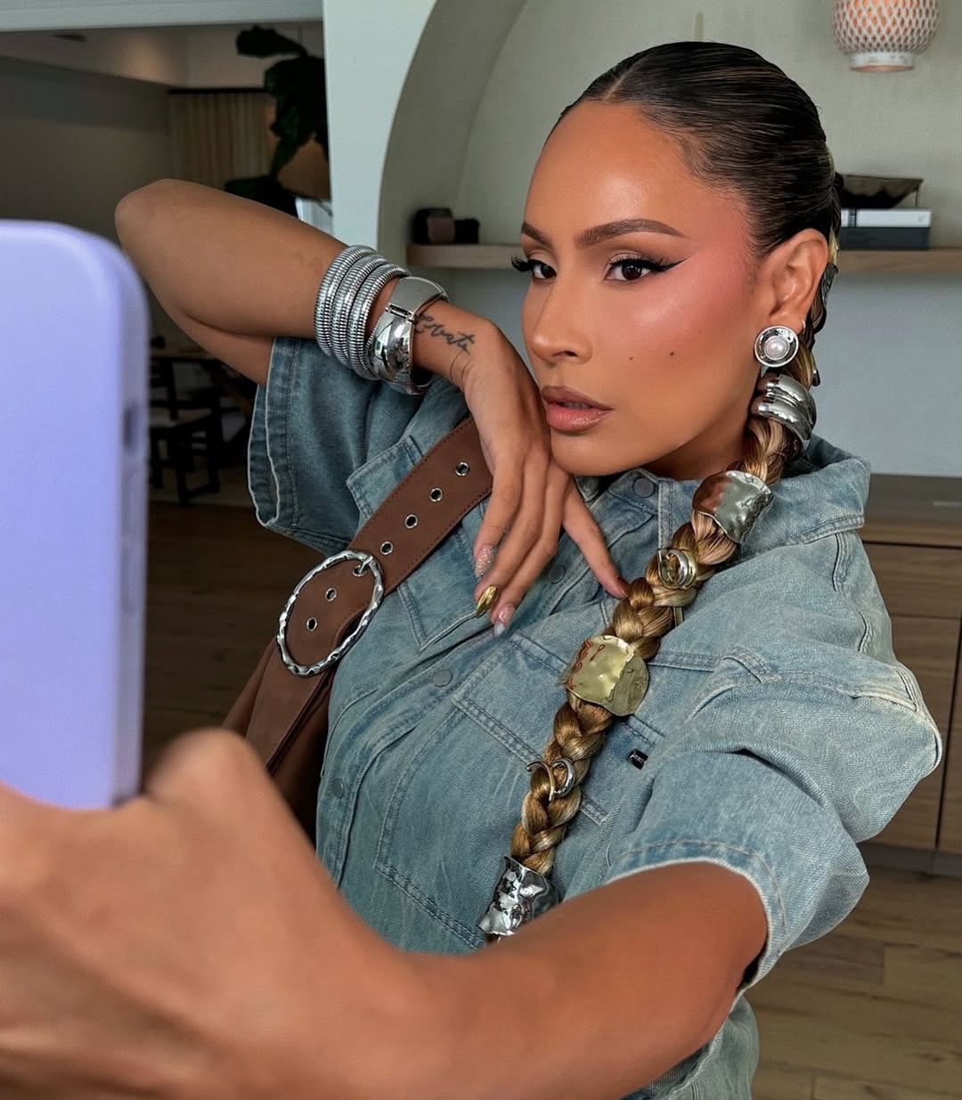 Deski Perkins wears a a sleek braids with chunky and minimalist hair accessories by Justine Marjan