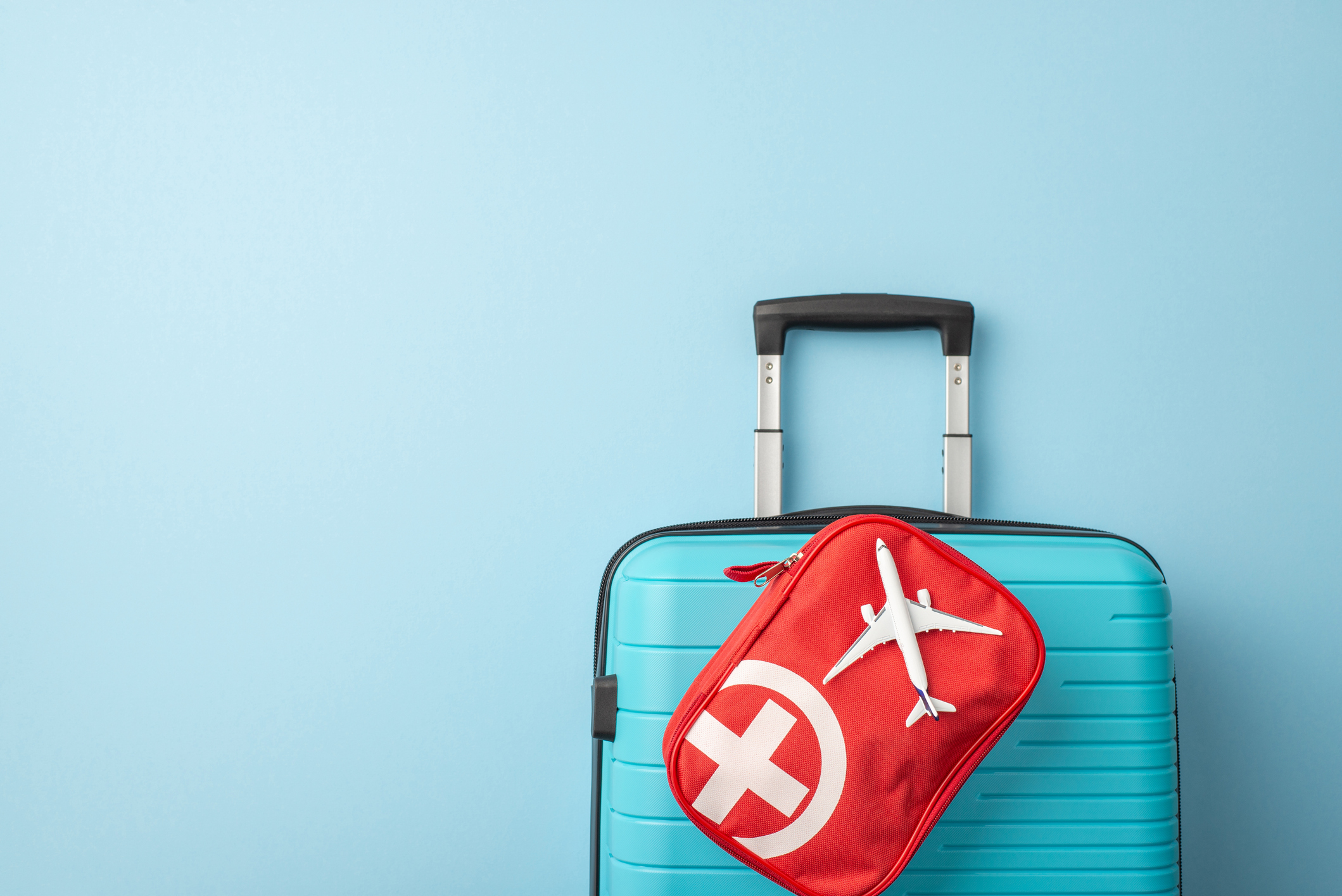 a picture of a suit case with a first aid kit attached