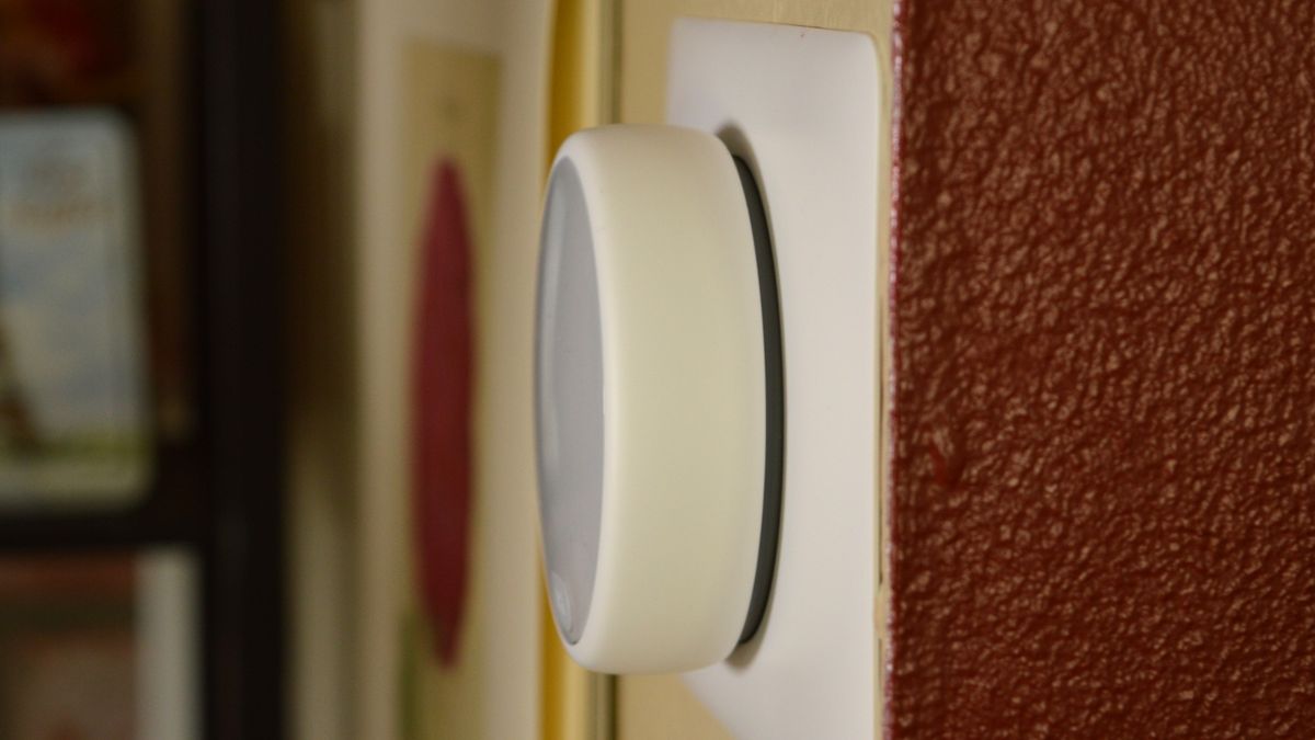 Side view of of Nest Thermostat E mounted on wall, showing how far its circular case protrudes into the room