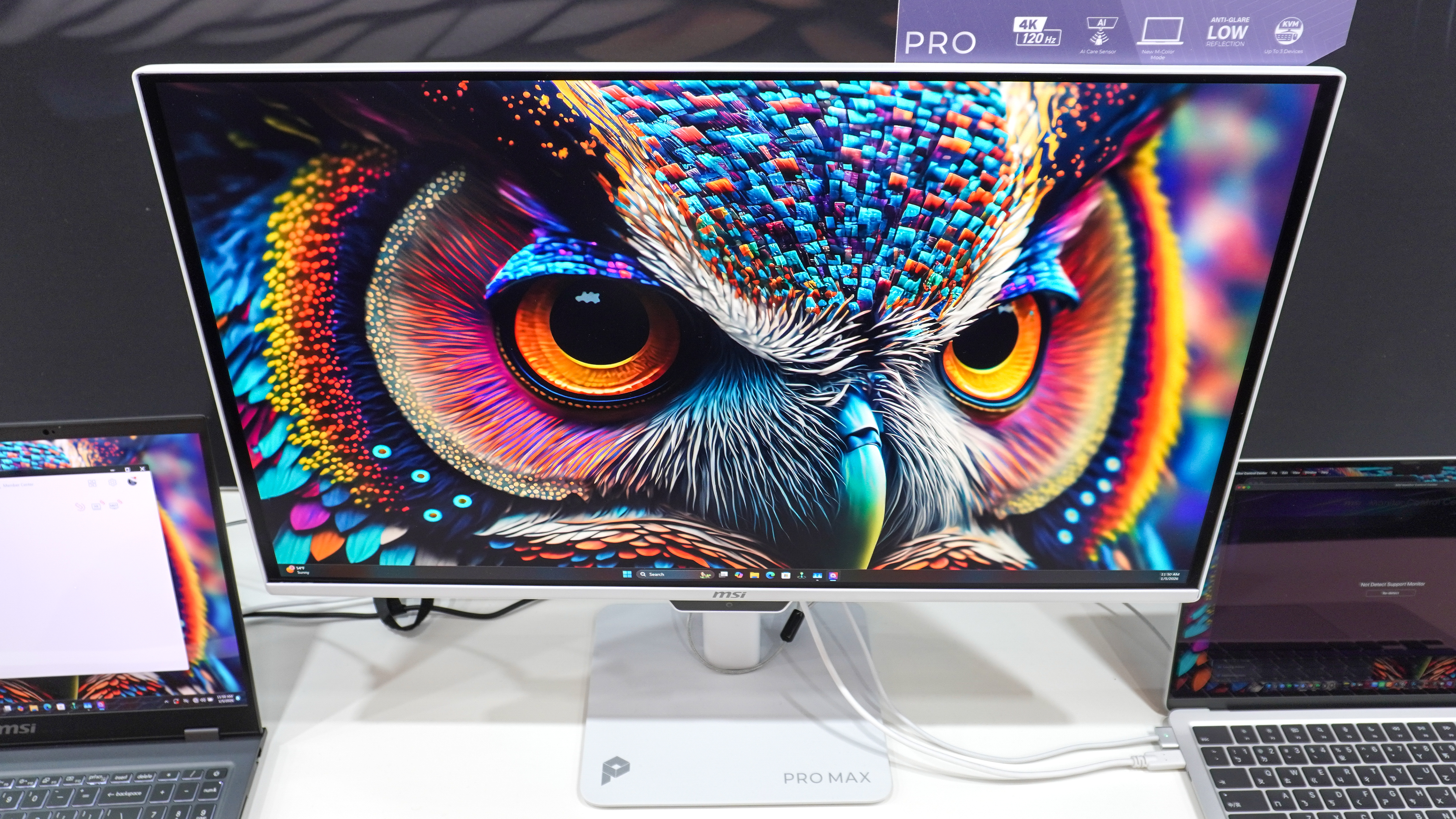 The MSI PRO MAX 271UPXW12G monitor hooked up to a MacBook and a Windows laptop at CES 2026