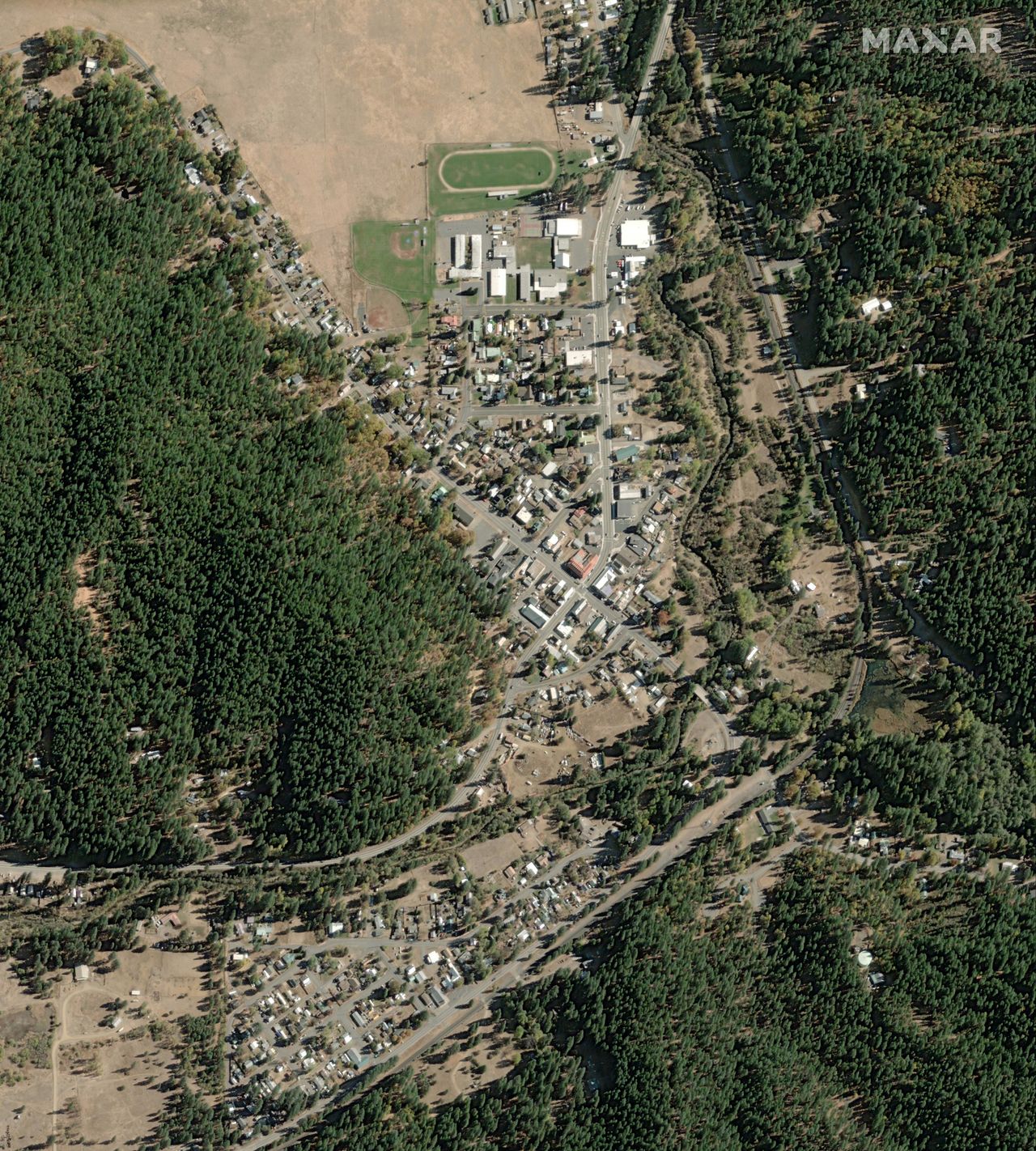 Before-and-after photos from Maxar's Worldview-1 satellite show the massive devastation of the California town Greenville by the Dixie Fire in August 2021.