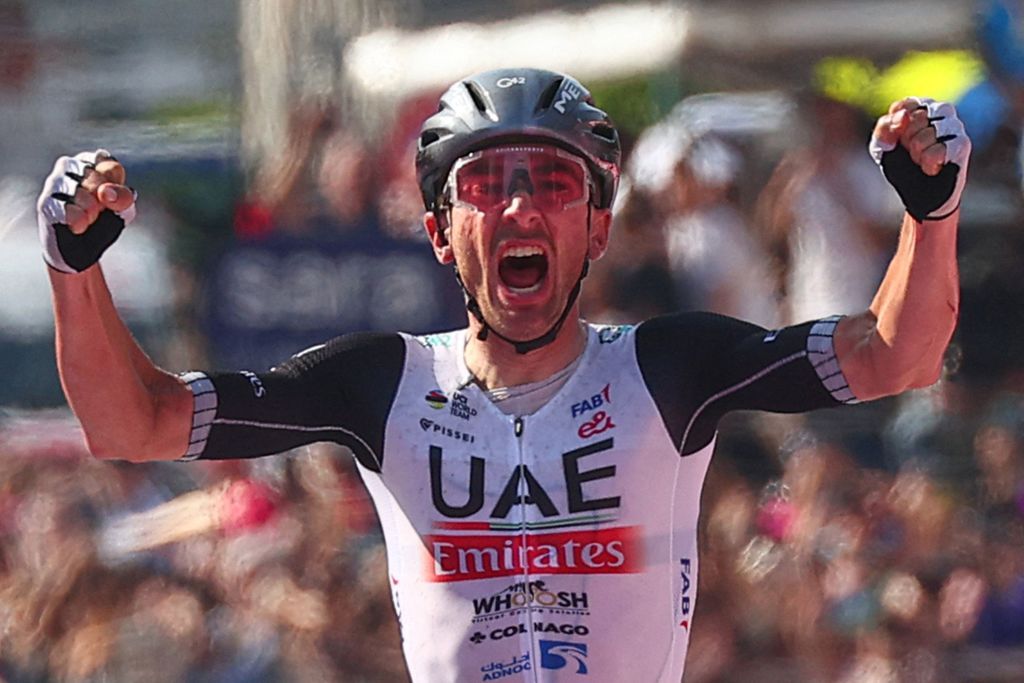 UAE Team Emiratess US rider Brandon McNulty celebrates as he crosses the finish line to win ahead of EF EducationEasyPosts Irish rider Ben Healy