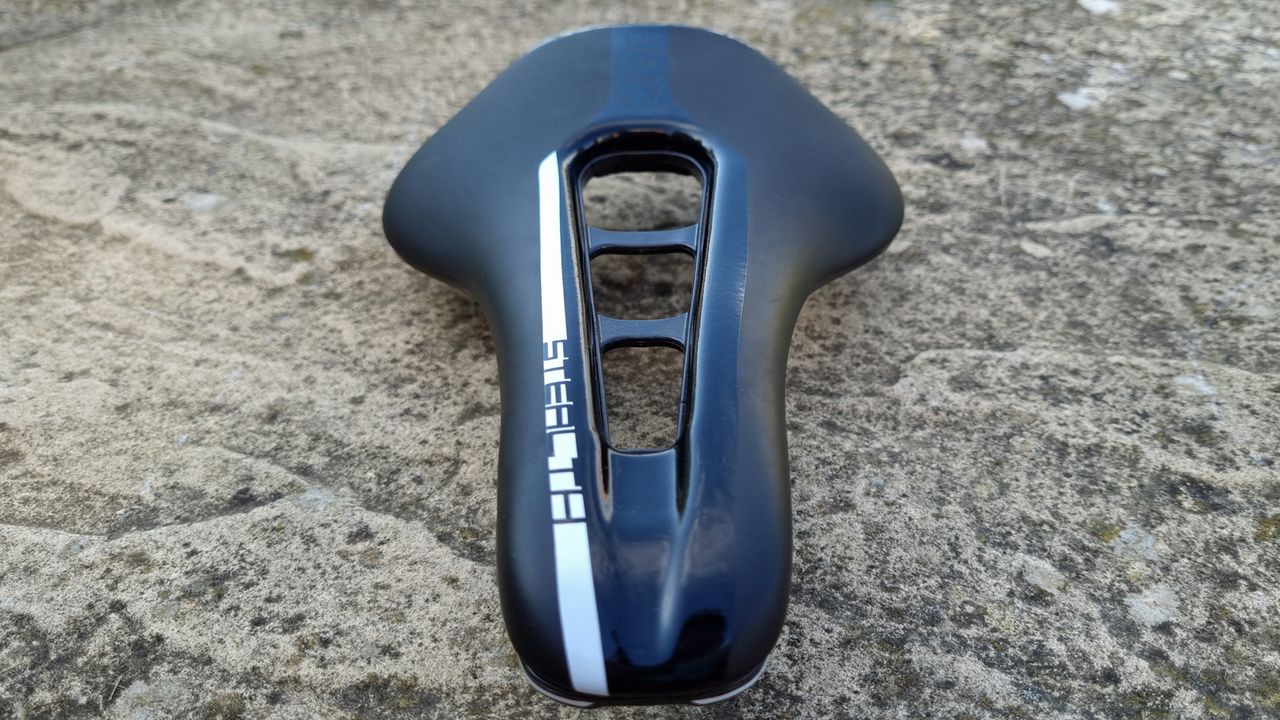 A close up of the Pro Stealth Carbon Saddle on a stone floor