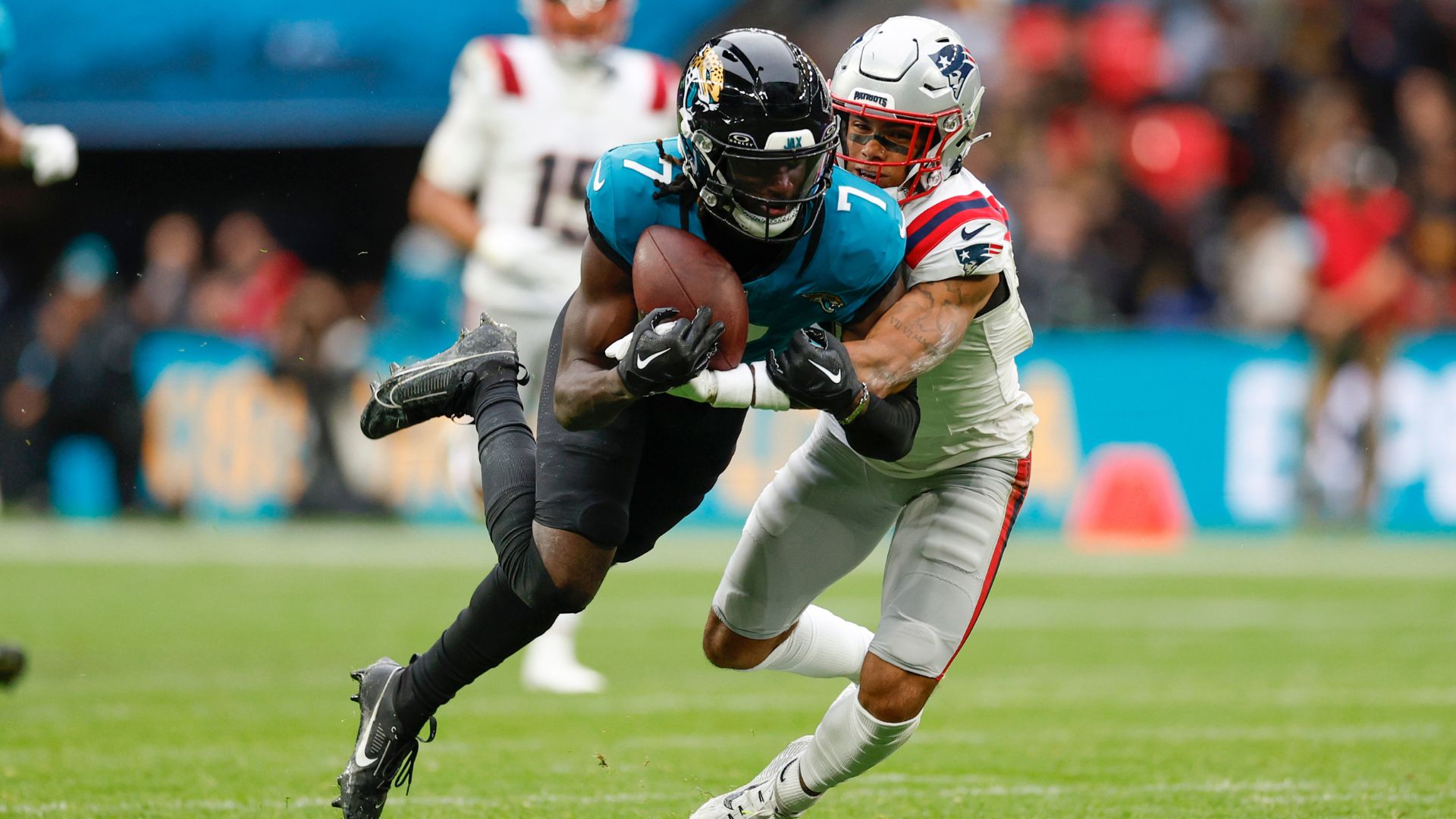 London, England - October 20: New England Patriots CB Christian Gonzalez tackles Jacksonville Jaguars WR Brian Thomas Jr. in the second quarter at Wembley Stadium