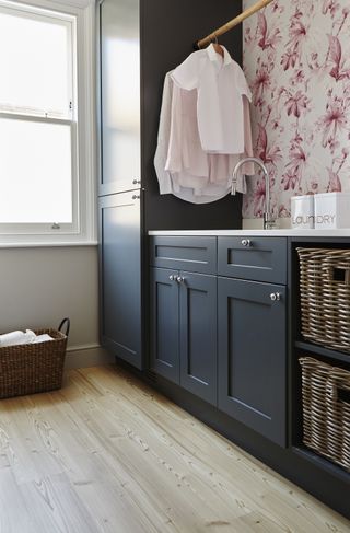 laundry room storage ideas with blue cabinets, hanging rail and built in storage by Lifestyle Floors