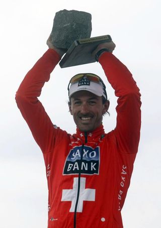 Fabian Cancellara raises his winner's cobblestone