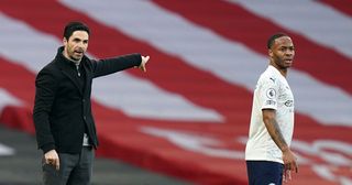 Arsenal manager Mikel Arteta (L) gestures on the touchline as Manchester City's English midfielder Raheem Sterling (R) looks on during the English Premier League football match between Arsenal and Manchester City at the Emirates Stadium in London on February 21, 2021.