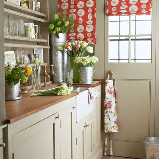 country utility room with flowers with red blind
