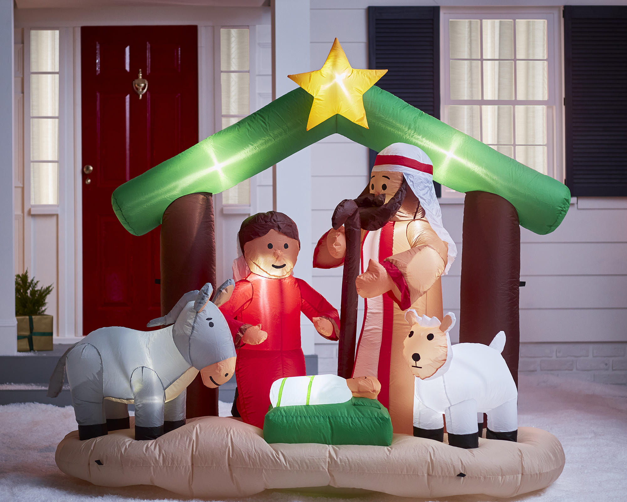 Nativity Scene Inflatable outside house with red front door and blue window shutters