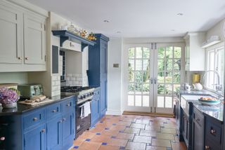 blue kitchen with terracotta tiles
